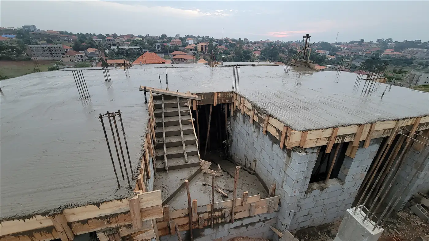 Completed and cured concrete suspended slab showing structural stair opening at Nsasa-Kira