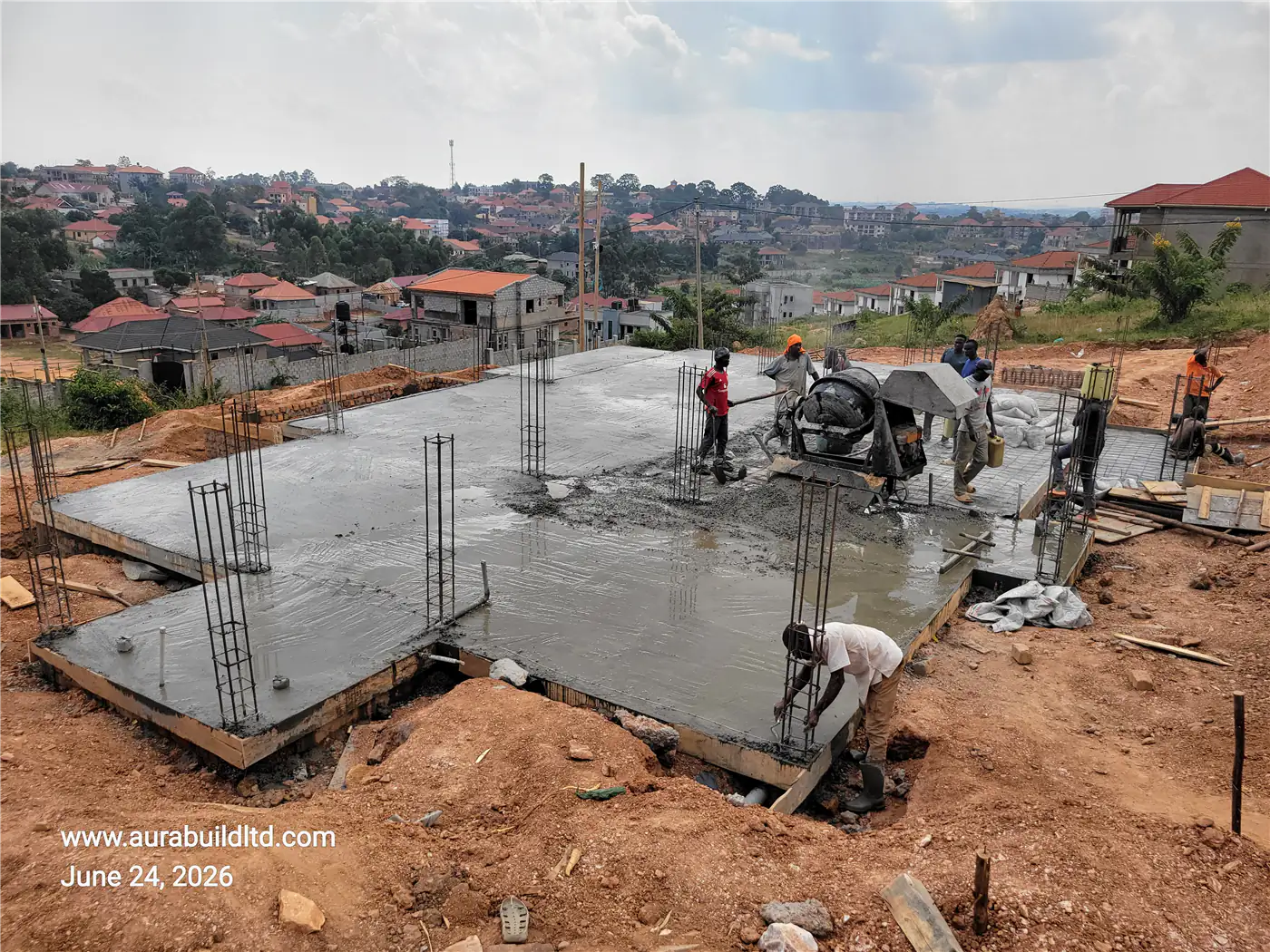 Pouring concrete for the ground floor slab at Nsasa-Kira residential site