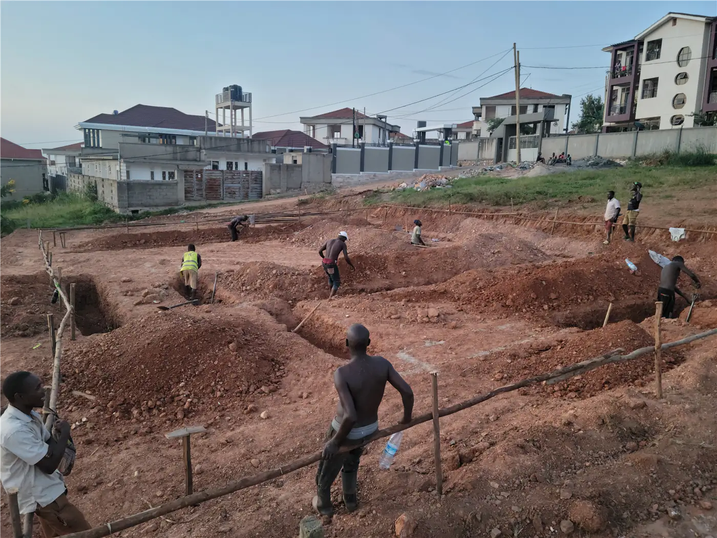 Aura Build Ltd team conducting site clearing and foundation setting out at Nsasa-Kira