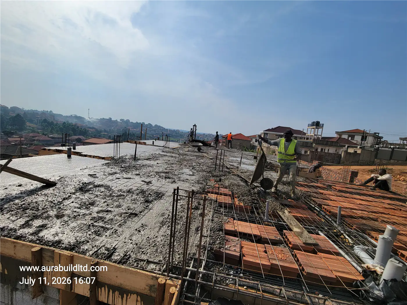 Casting concrete onto the suspended slab structure at Nsasa-Kira