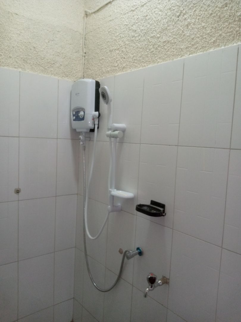 Shower water heater and plumbing fully installed near completion of bathroom renovation